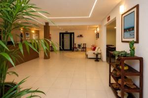 a hallway with a living room and a couch at Pousada Mangaba Sergipe in Aracaju