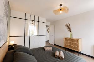 a bedroom with a bed and two pairs of shoes at M a g i c & J u n g l e in Verdun-sur-Meuse