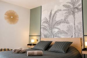 a bedroom with a bed with a large painting on the wall at M a g i c & J u n g l e in Verdun-sur-Meuse