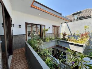 a garden on the balcony of a house at Ramantika Sunset Bay in Nusa Dua