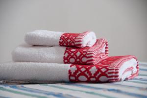 a stack of folded towels on a bed at Three Tails House in Capezzano Pianore, +28 photos