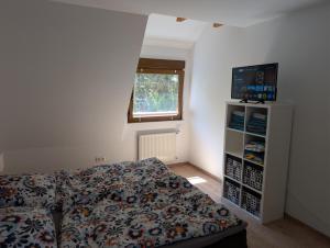 a small bedroom with a bed and a window at Ferienwohnung am Hainer Berg in Heigenbrücken
