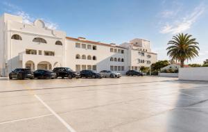 a parking lot in front of a building at ENJOY POOL, BEACH and more at this nice 2bedroom apartment only 3 minutes from Mareta's Beach in Sagres