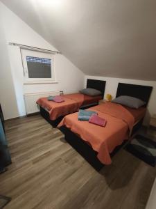 a room with two beds and a window at Apartment Velebit with swimming pool - 10km from sea - 20km from Zadar in Benkovac +21 photos