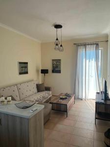 a living room with a couch and a table at Karfas Seascape in Chios