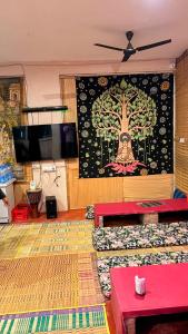 a room with a wall with a painting of a tree at Italian cafe Hampi in Hampi