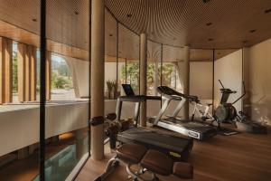 a room with a gym with a treadmill and a laptop at Hotel Col Alto in Corvara in Badia