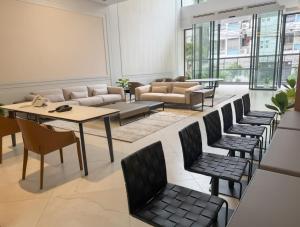 a living room with a table and chairs at Barobi Apartment in Solpur