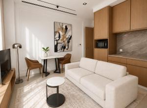 a living room with a white couch and a table at Barobi Apartment in Solpur