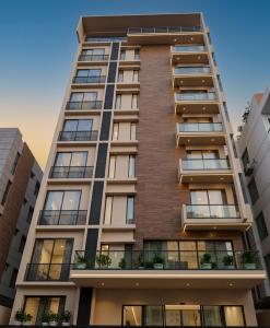a tall apartment building with balconies at Barobi Apartment in Solpur
