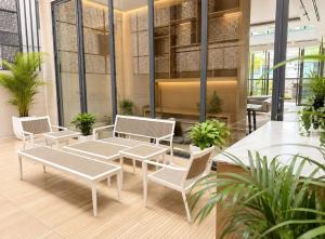 a group of tables and chairs in a lobby at Barobi Apartment in Solpur +2 photos