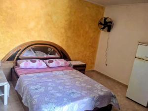 a bedroom with a bed with pink pillows on it at Lionz Village in Skala Fourkas