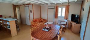 a living room with a table and a couch at Gite De Baunac in Aubas