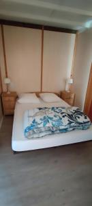 a white bed with a blue and white blanket on it at Gite De Baunac in Aubas +13 photos