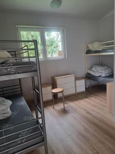 a dorm room with bunk beds and a window at OW Viva in Jantar