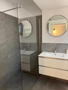 a bathroom with a shower and a sink and a mirror at Condhotel Fanti Ski & Bike in Valdisotto