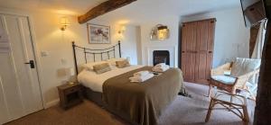 a bedroom with a bed with towels on it at The Poppy House in Bishops Castle