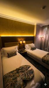 a hotel room with two beds in a room at Hôtel Saint Eugène in Bab el Oued