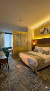 a hotel room with a bed and a desk at Hôtel Saint Eugène in Bab el Oued