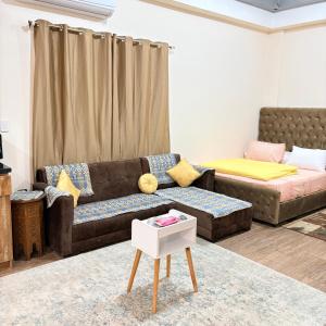a living room with a couch and a table at Studio near airport in Cairo