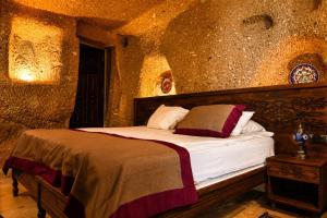 a bedroom with a bed in a stone wall at la mar cave cappadocia in Ürgüp +7 photos