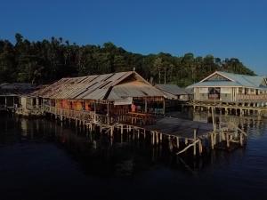 a group of houses on a dock on the water at Losmen Togean Wisata in Pulau Togian +18 photos