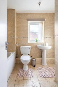 a bathroom with a toilet and a sink at Bright Double Room with Shared Bathroom in Luton