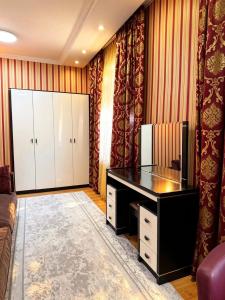 a home office with a desk and curtains at Seoul Hotel in Shymkent +24 photos