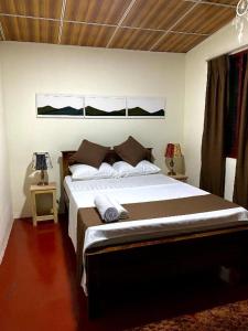 a bedroom with a large bed in a room at Yasindu Riverfront Villa in Balapitiya