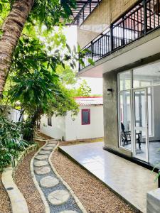 an external view of a house with a garden at Yasindu Riverfront Villa in Balapitiya