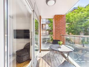 a room with a balcony with a table and a chair at Westminster Residences by Apt in London