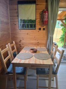 a wooden table and chairs in a room at Śledziowy Domek 