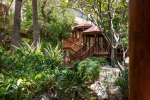 a house with a deck in the woods at Gulf Executive Residence in Manama