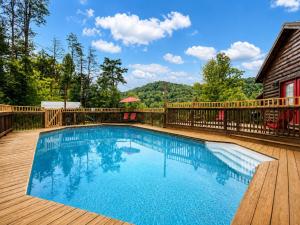 a swimming pool on a deck next to a house at Starry Mountain Night- Private Pool, Pool Table in Stanton