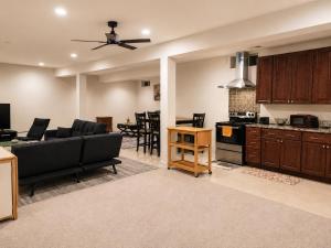 a living room with a couch and a kitchen at Spacious Studio by the Woods in Laurel