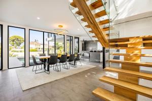 an open kitchen and dining room with a table and chairs at Bluewater Oasis - Stay 4 Pay 3 in Gold Coast