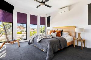 a bedroom with a bed and large windows at Bluewater Oasis - Stay 4 Pay 3 in Gold Coast +21 photos