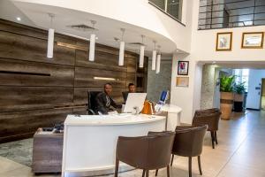 two men sitting at a desk in an office at Leola Boutique Hotel Ikeja - Lagos in Lagos +22 photos