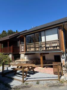 a house with a picnic table in front of it at Chalet Albert in Bolquere Pyrenees 2000