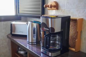 a coffeemaker and a coffee maker on a counter at Casa Argelio in Alojera +24 photos