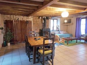 a living room with a wooden table and a dining room at Gite Fée Grenouille in Martigny-le-Comte +24 photos