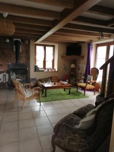 a living room with a couch and a table at Gite Fée Grenouille in Martigny-le-Comte