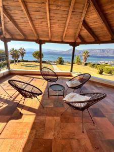 a group of chairs sitting on a patio at Beachfront Villa Tranquility in Longós
