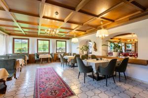 a restaurant with tables and chairs in a room at Hotel Elisabeth in Schoppernau