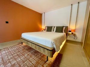 a bedroom with a large bed in a room at Calheta Suites - Vinha & Jardim - Adults-only suites met hottub & zeezicht in Calheta