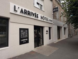 a store with a sign on the side of a building at Brit Hotel L'Arrivée Guingamp in Guingamp