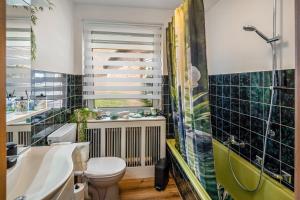 a bathroom with a toilet and a sink and a shower at Land Leben Wohnung 1 in Erkelenz +21 photos