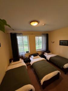 a room with four beds in it with windows at Auksinė giria in Kernavė +29 photos