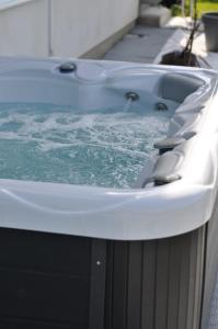 a bath tub filled with water on a sidewalk at Villa Saraj with Swimming Pool & Jacuzzi near Sarajevo in Sarajevo +75 photos