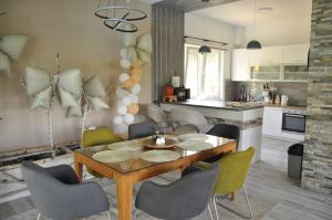 a kitchen and dining room with a table and chairs at Villa Saraj with Swimming Pool & Jacuzzi near Sarajevo in Sarajevo